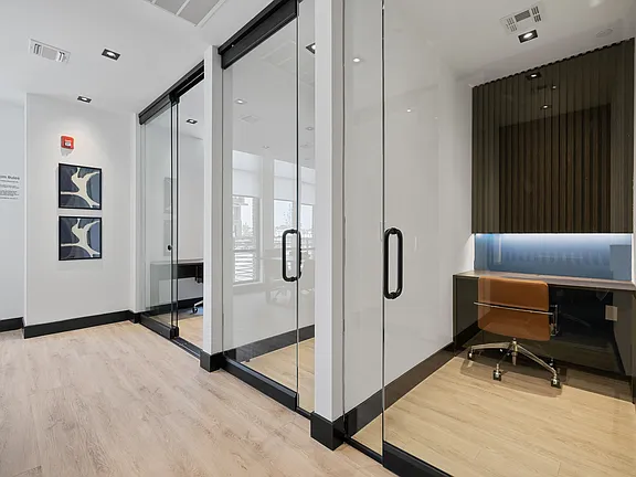 The Breton, multifamily by HH Designers in Bayonne, NJ, glass front conference rooms and work pods