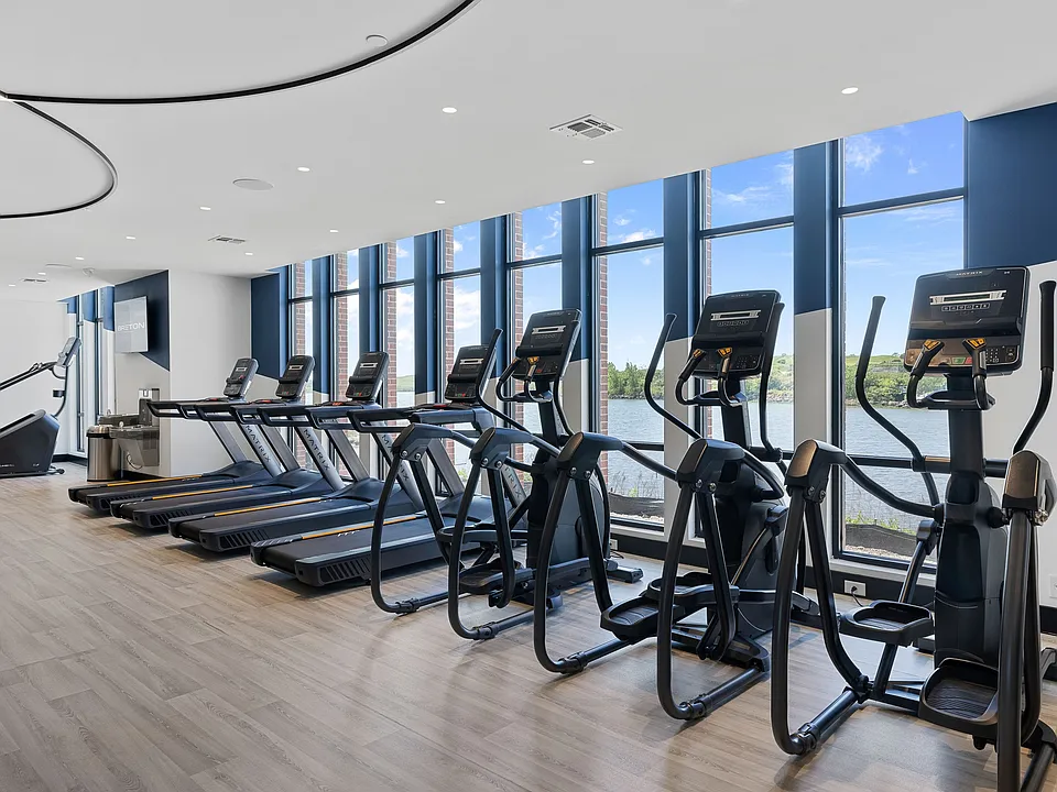 The Breton, multifamily by HH Designers in Bayonne, NJ, fitness center with water views