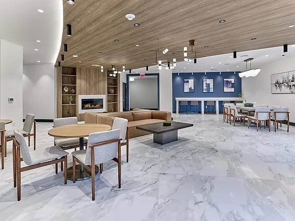 The Breton, multifamily by HH Designers in Bayonne, NJ, resident lounge with fireplace and demonstration kitchen