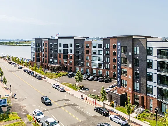 The Breton, multifamily by HH Designers in Bayonne, NJ, aerial view of the facade and waterfront