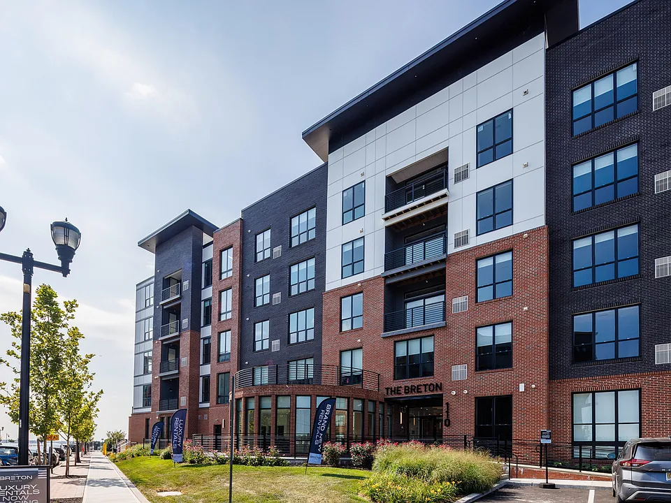 The Breton, multifamily by HH Designers in Bayonne, NJ, street entrance with brick rotunda