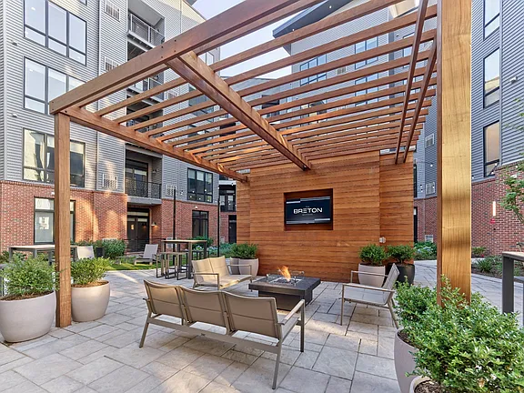 The Breton, multifamily by HH Designers in Bayonne, NJ, pergola lounge with outdoor TV