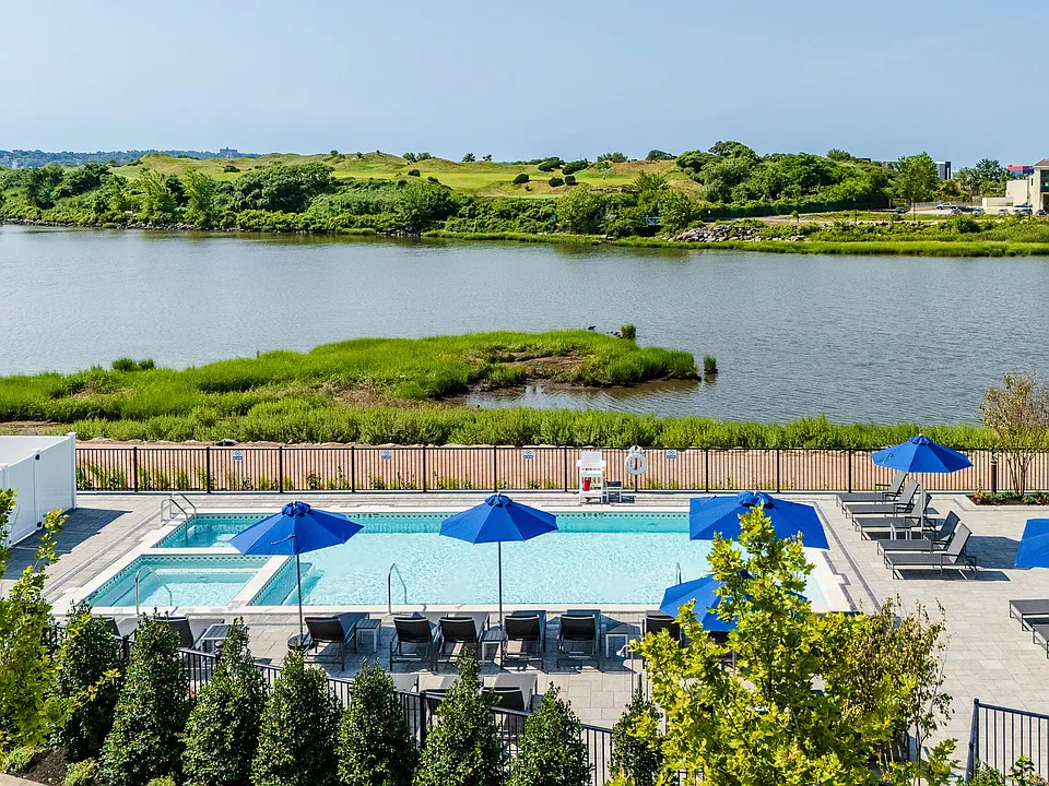 The Breton, multifamily by HH Designers in Bayonne, NJ, elevated view over the pool and open water