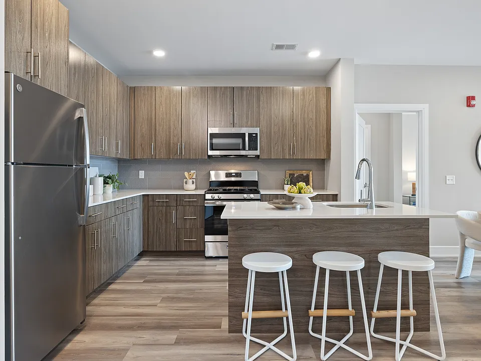 The Breton, multifamily by HH Designers in Bayonne, NJ, open kitchen with island seating