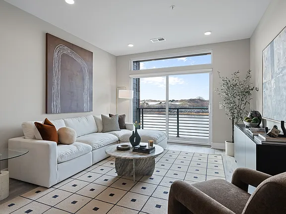 The Breton, multifamily by HH Designers in Bayonne, NJ, living room with balcony access