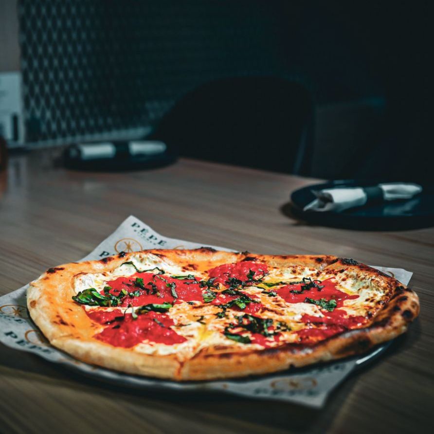 Pizza served beside Pēpe Kitchen's perforated-steel screens