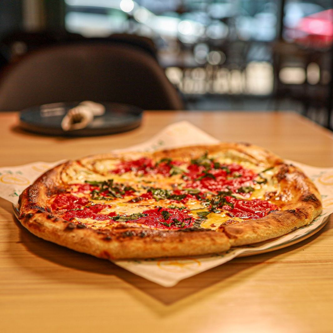 Neapolitan pizza served at a table inside Pēpe Kitchen
