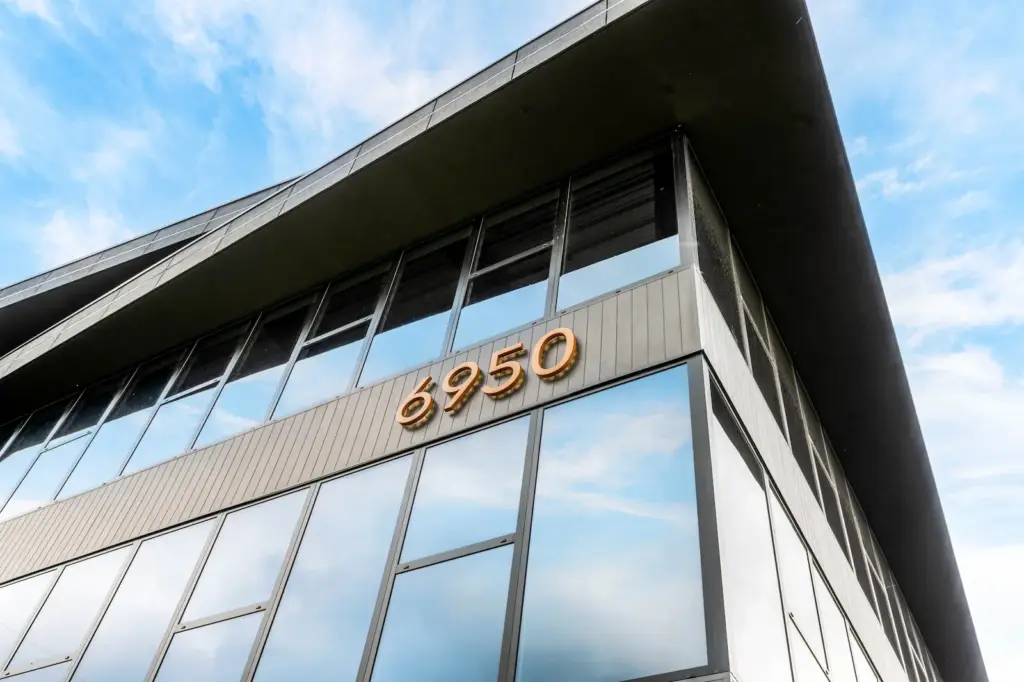 Copper 6950 address numerals on the glass curtain wall of The Edge in Howell, NJ